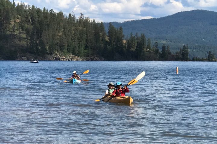 a group of people rowing a boat in a body of water