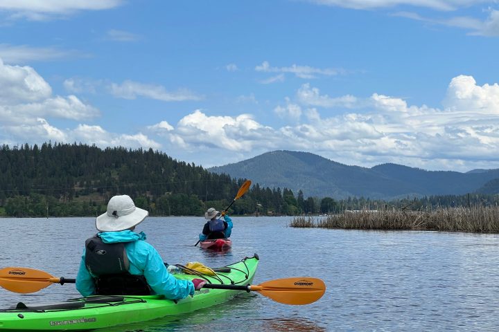 a group of people sitting in a boat on a body of water