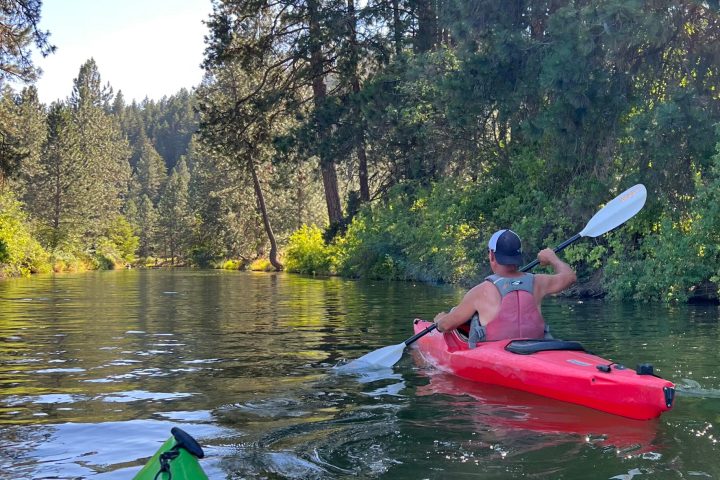 a person in a green boat on a lake
