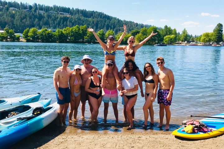 a group of people on a beach posing for the camera